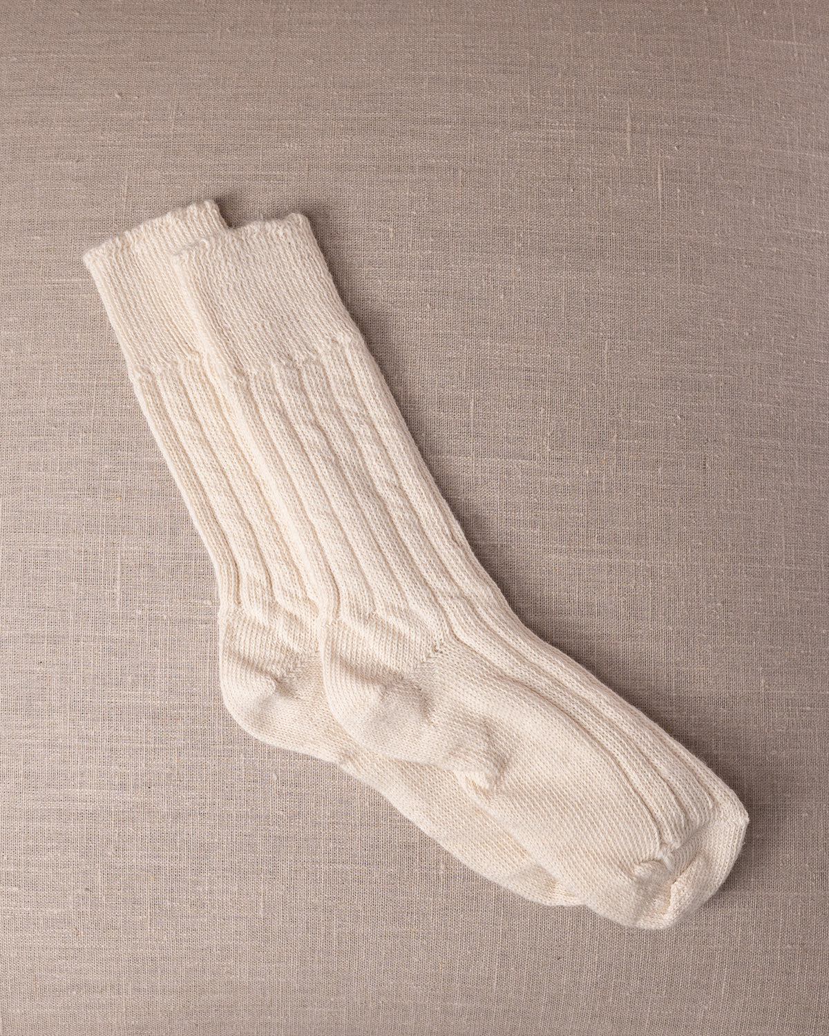 White socks on a beige textured background