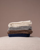 Stack of socks in various colours on a neutral background