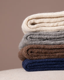 Stack socks in various colours on a neutral background
