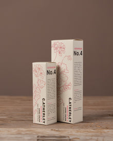 Two boxes of C. Atherley hand cream on a wooden surface with a brown background