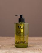 Bottle of C. Atherley No. 4 hand wash on a wooden surface with a brown background