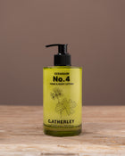 C.atherley Geranium No.4 hand and body lotion bottle on a wooden surface with a brown background