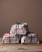 Three packages of D. Barbero Panetonne on a wooden surface with a brown background