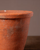 Close-up of a terracotta pot with a brown background