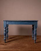 Blue wooden table against a brown wall