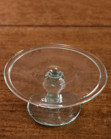 Clear glass candle holder on a wooden surface