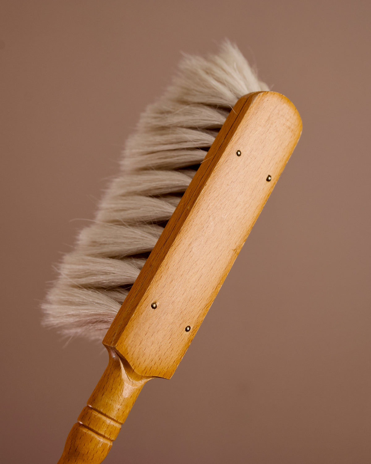Wooden cleaning brush with white bristles